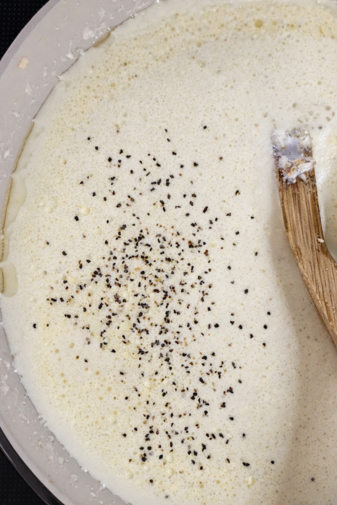 Season lightly with black pepper. Add salt only if needed — Parmesan is naturally salty.