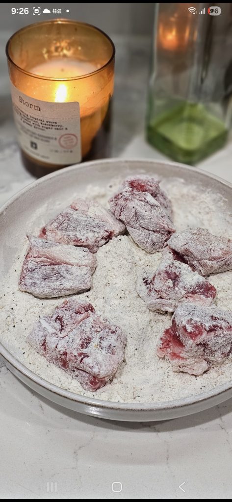 Toss beef chunks in the flour and spice mix
