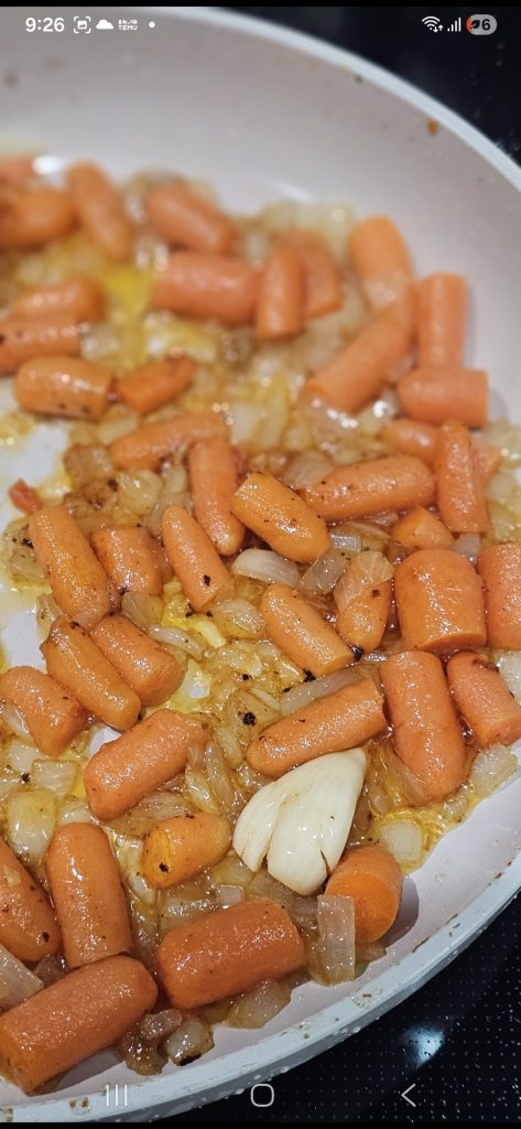 In the same skillet, sauté onions and carrots for 5 minute
