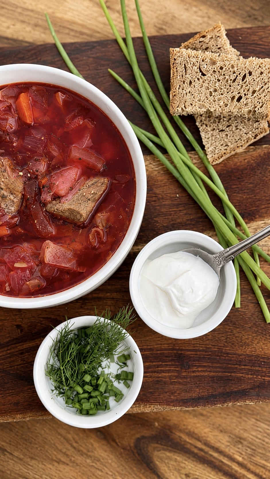 A bowl of authentic Eastern European pork borscht with tender pork,